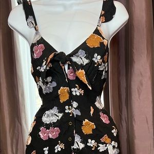 Floral romper with spaghetti straps and buttons down the front
